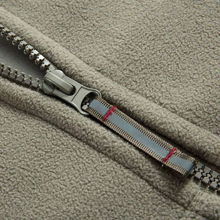 Close-up of waterproof zipper on unisex thermal fleece tactical jacket, windproof winter coat