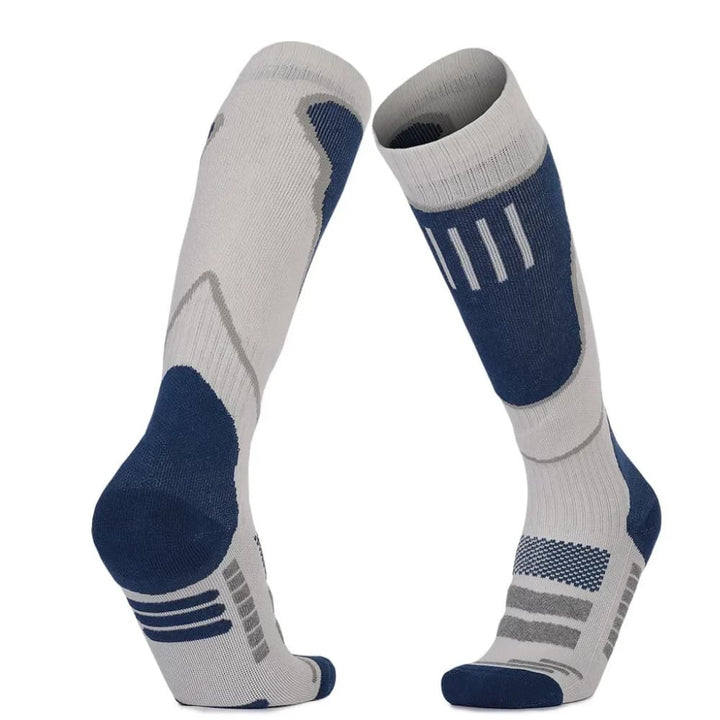 Cushioned ski and snowboard socks, grey with orange details, providing warmth and support for winter activities.