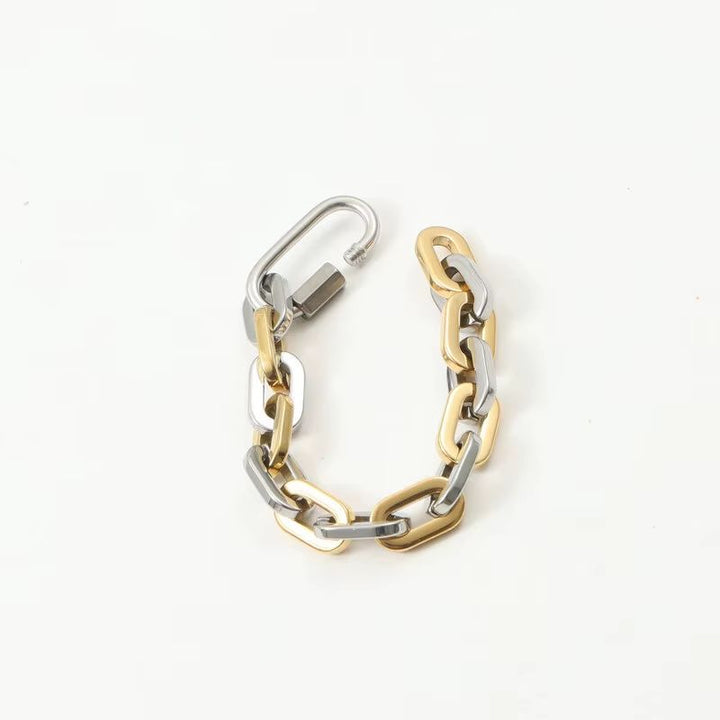 Stylish unisex two-tone carabiner bracelet, a chunky gold-plated stainless steel fashion jewelry piece.
