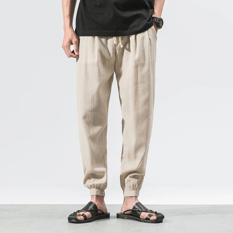 Model wearing comfortable, relaxed fit unisex joggers, showcasing deep pockets and soft cotton blend.