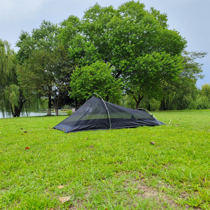 Unisex 1-person tent pitched at sunset, glowing with ambient light, perfect for solo camping.