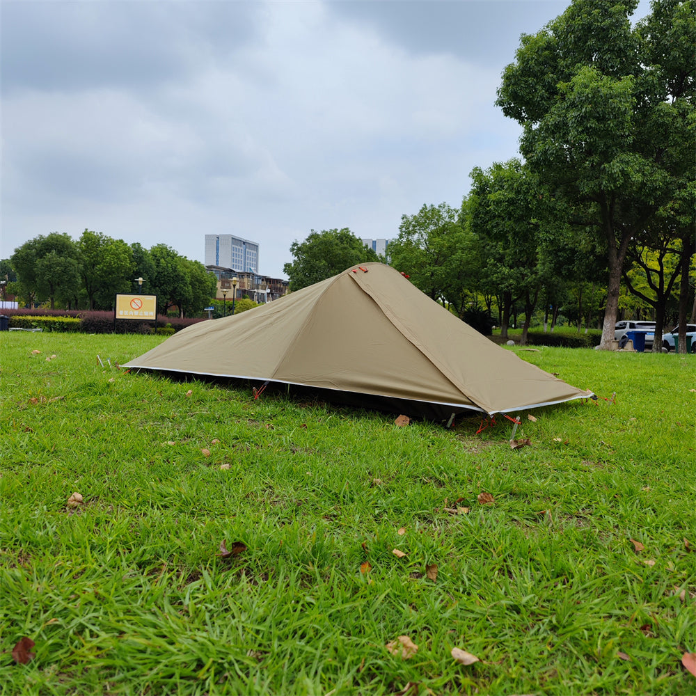 Happy hiker emerging from an ultralight 1-person tent, enjoying the freedom of solo camping.