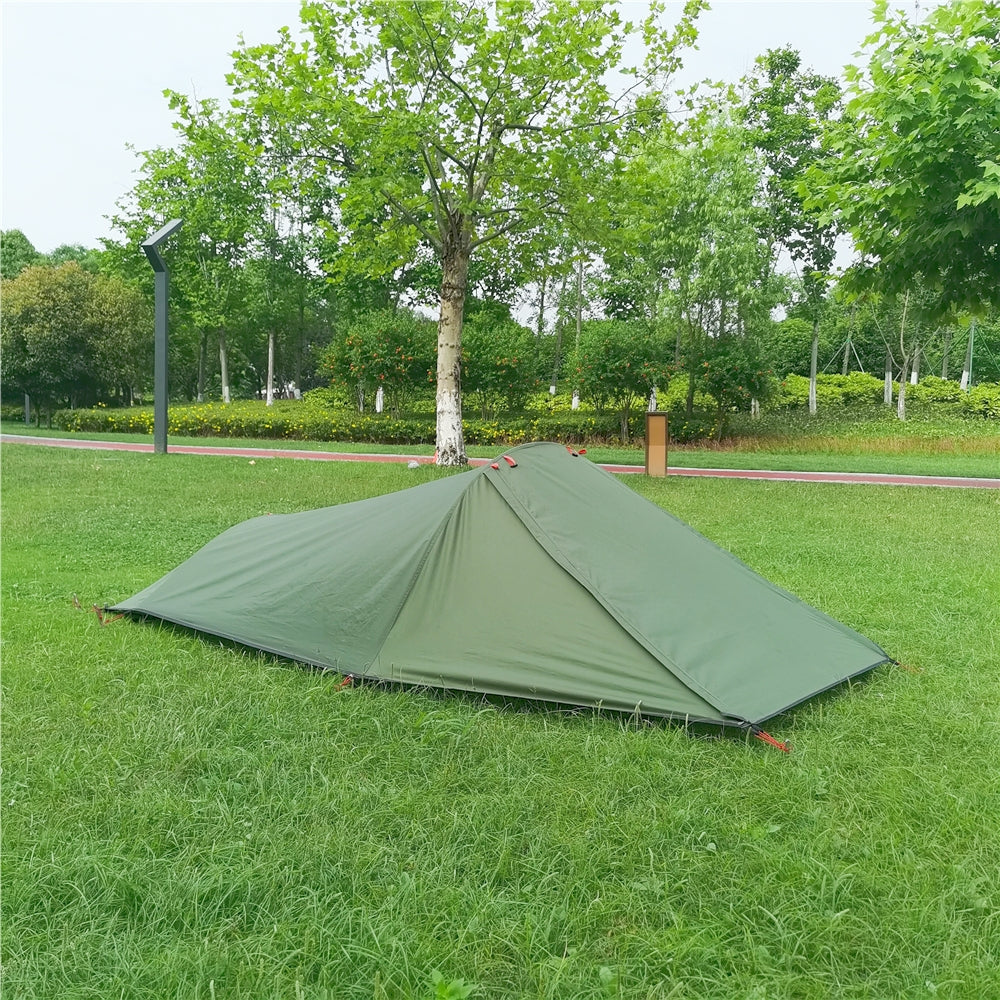 Unisex 1-person all-season backpacking tent freestanding, set up in a lush forest for solo adventure.