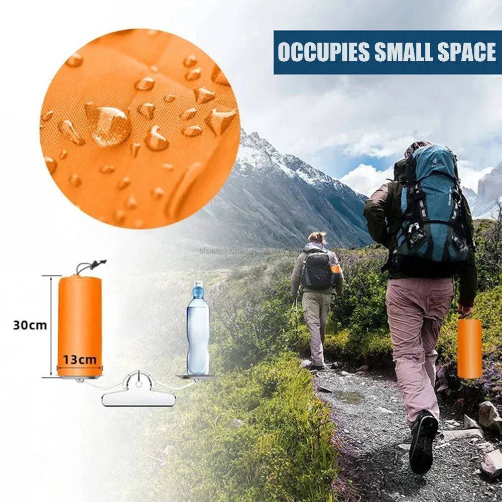 Durable inflatable camping mattress with built-in pump, unrolled on tent floor, ready for use