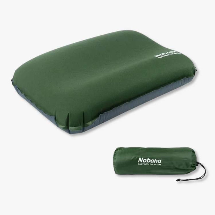 Deflated ultralight camping pillow in its stuff sack, ready for backpacking and travel.