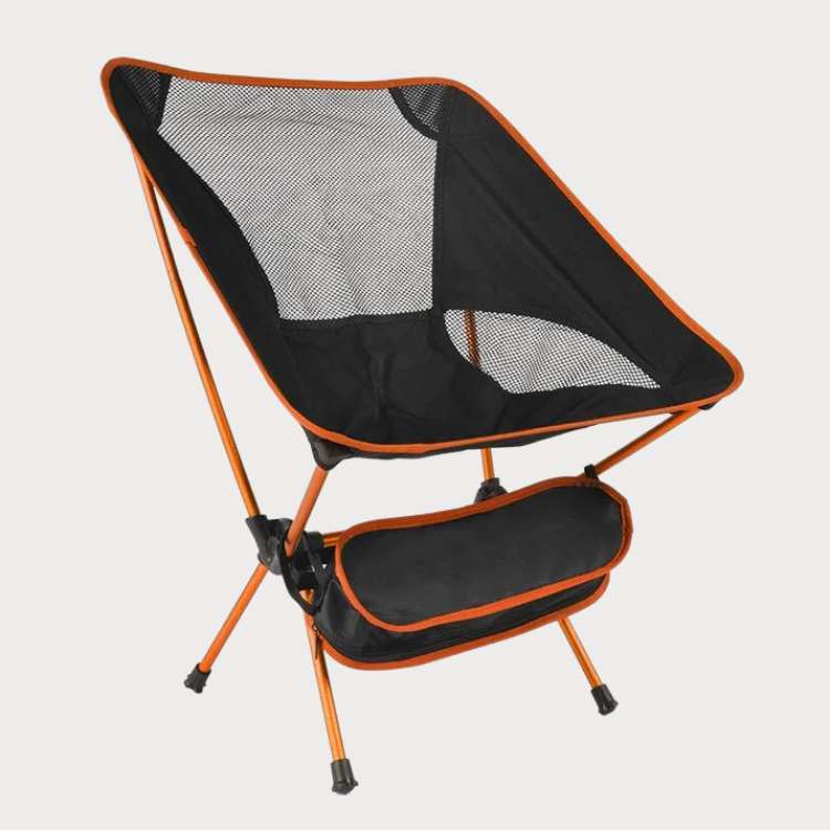 Unisex ultralight portable folding camp chair in black, unfolded on green grass, ideal for camping and hiking.