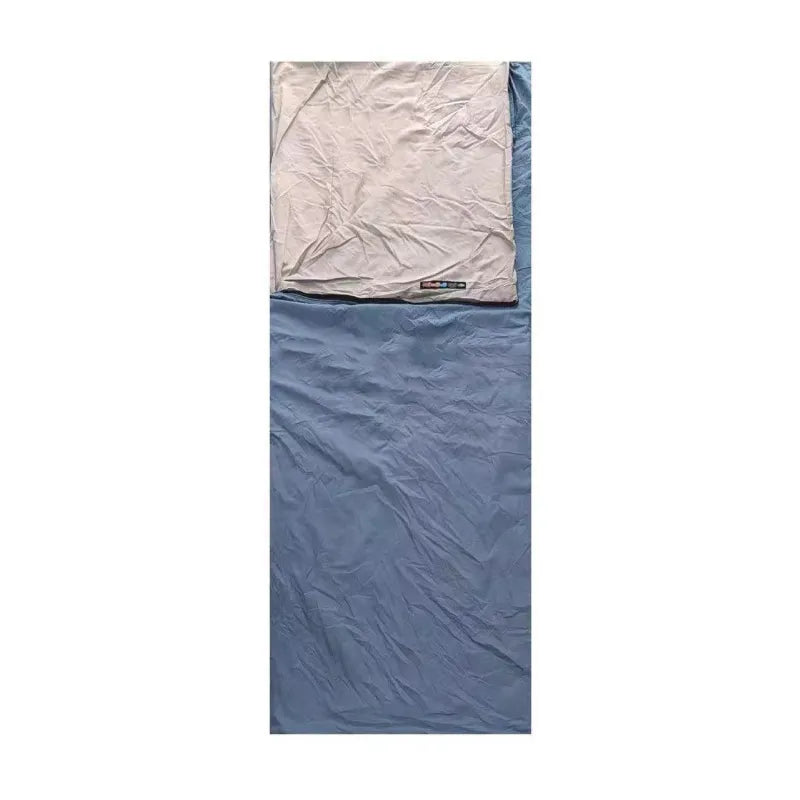 Water-resistant camping sleeping bag in an outdoor setting, open and ready for use
