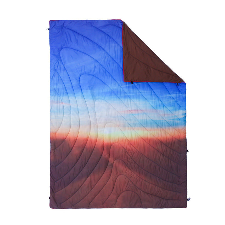 Cozy camping blanket used as an extra layer over a sleeping bag.