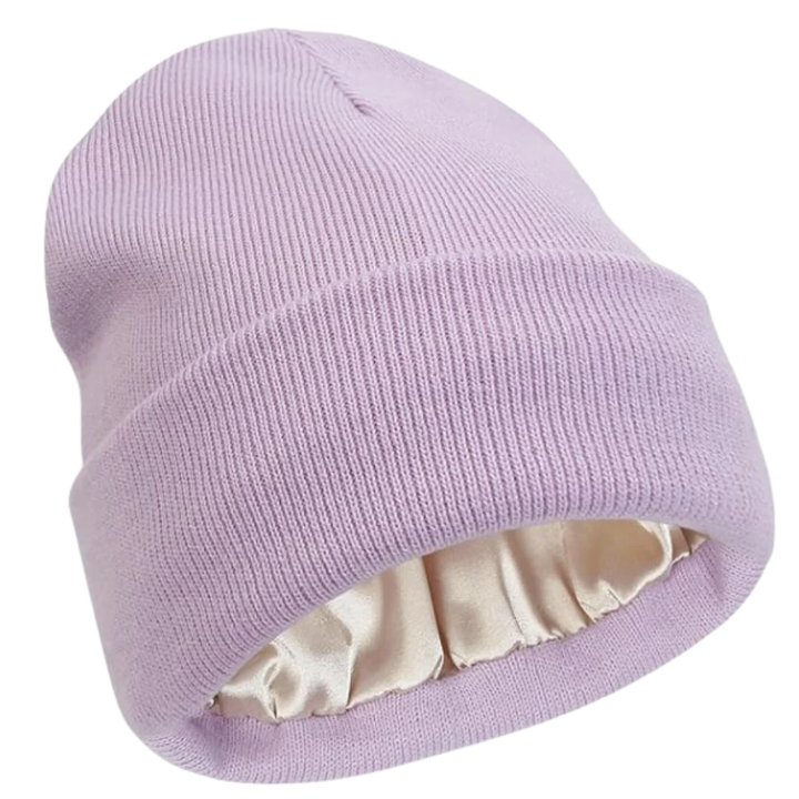 Close-up of a warm knit beanie with visible satin lining, showcasing hair protection features.