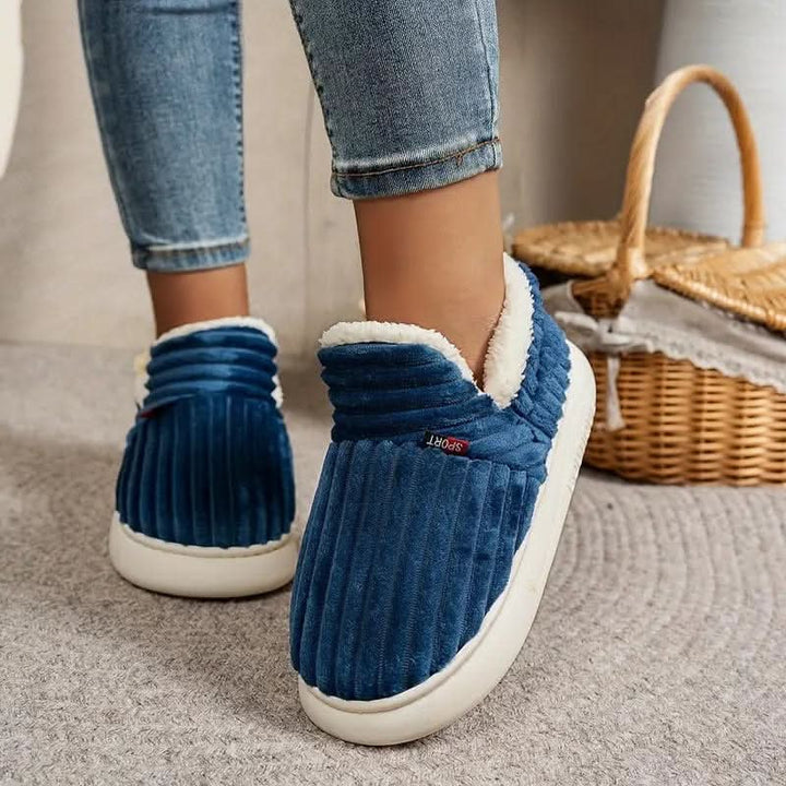 Comfortable unisex winter slippers with thermal lining & durable non-slip sole.