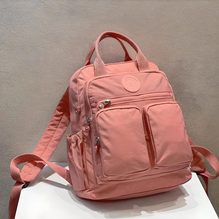 Durable unisex commuter bag: waterproof, sleek urban design, ample storage pockets.