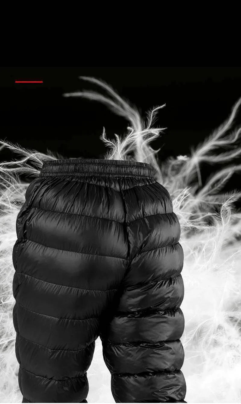 Pair of black down-filled hiking pants, folded, highlighting insulation and warmth