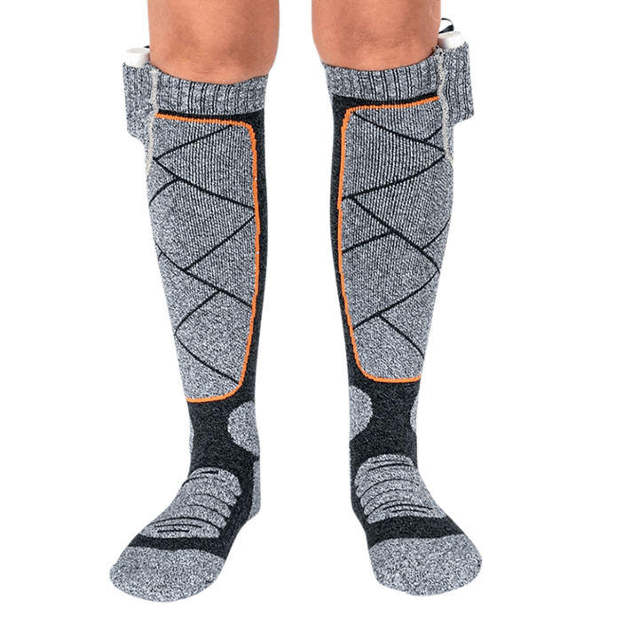 Unisex winter heated socks powered by a small power bank for cold weather outdoor activities.