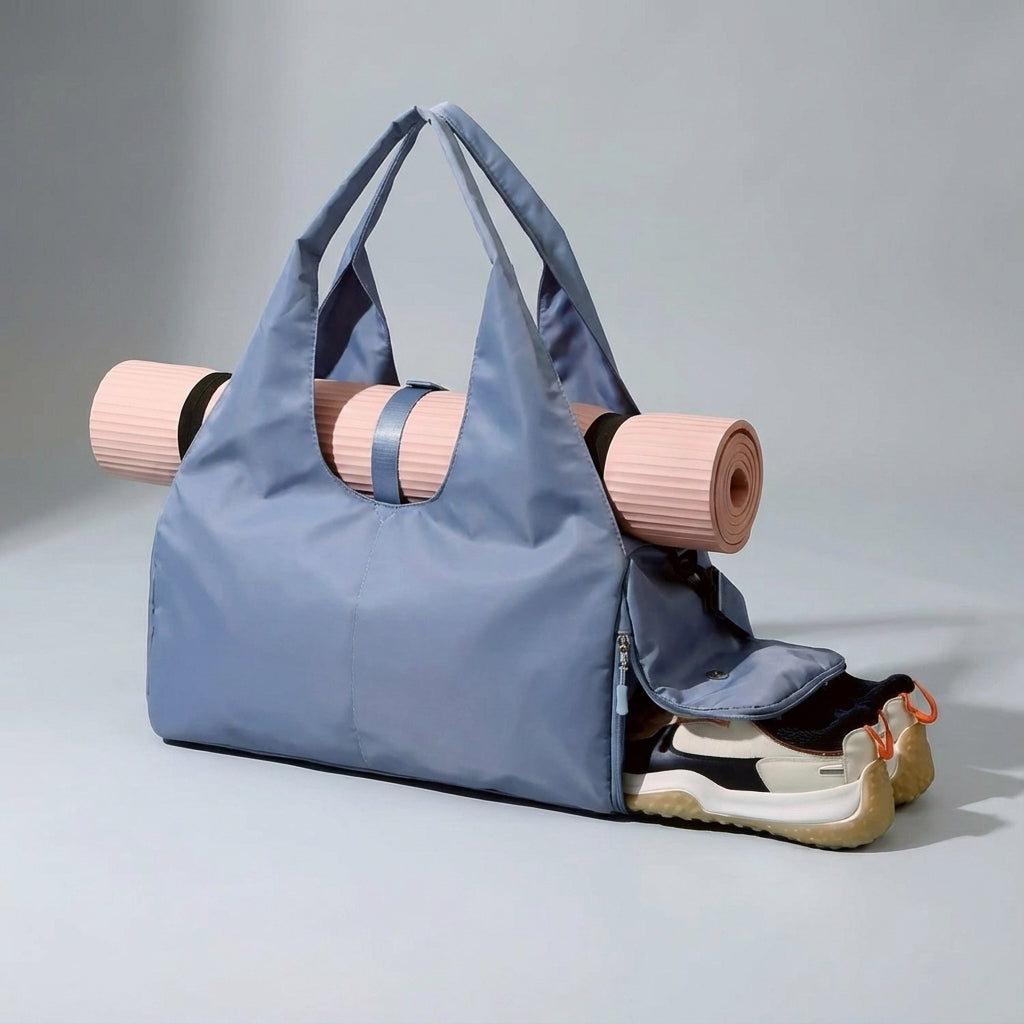 Unisex yoga duffel bag featuring a secure mat holder, wet pocket, & dedicated shoe compartment.