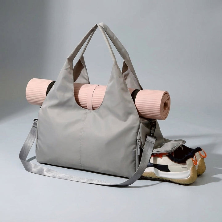 Practical unisex duffel bag for yoga & travel, with wet pocket, shoe compartment, & mat strap.