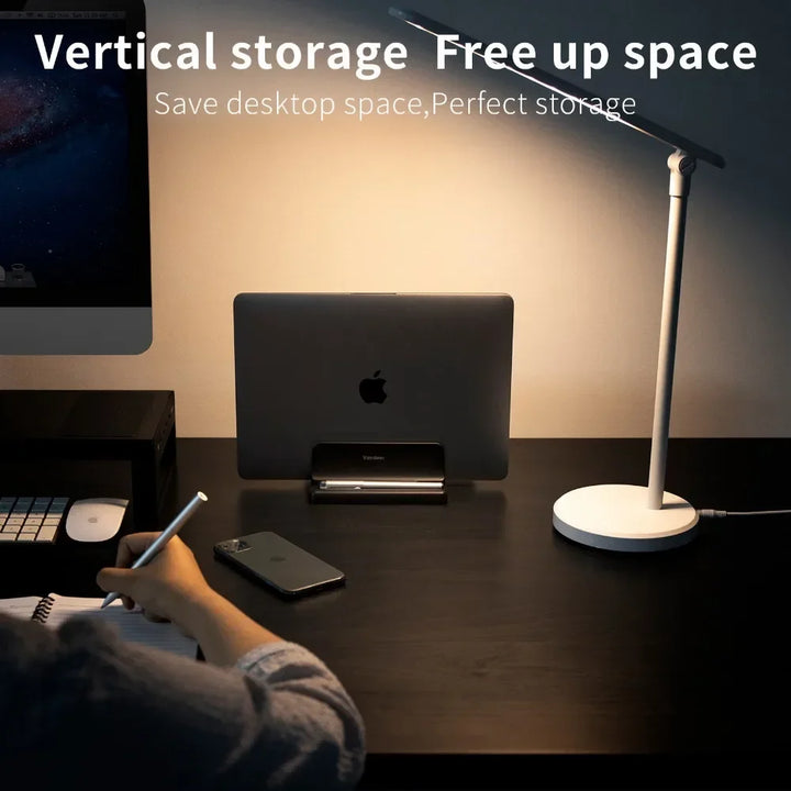 Adjustable universal vertical laptop stand for desks. Organizes tech accessories, saves home office space.