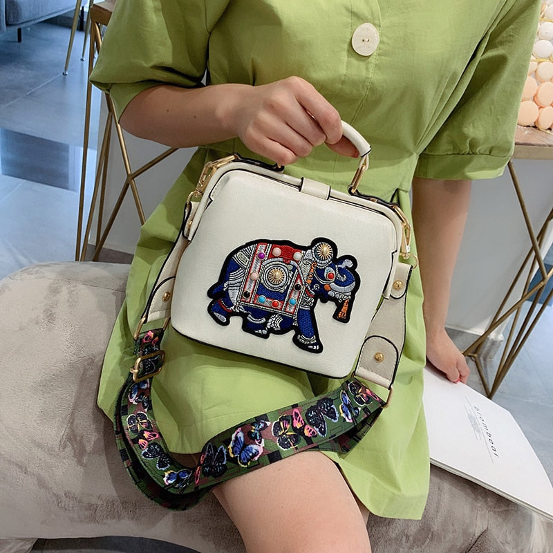 Detailed shot of the durable fabric and mandala embroidery on a women's purse.