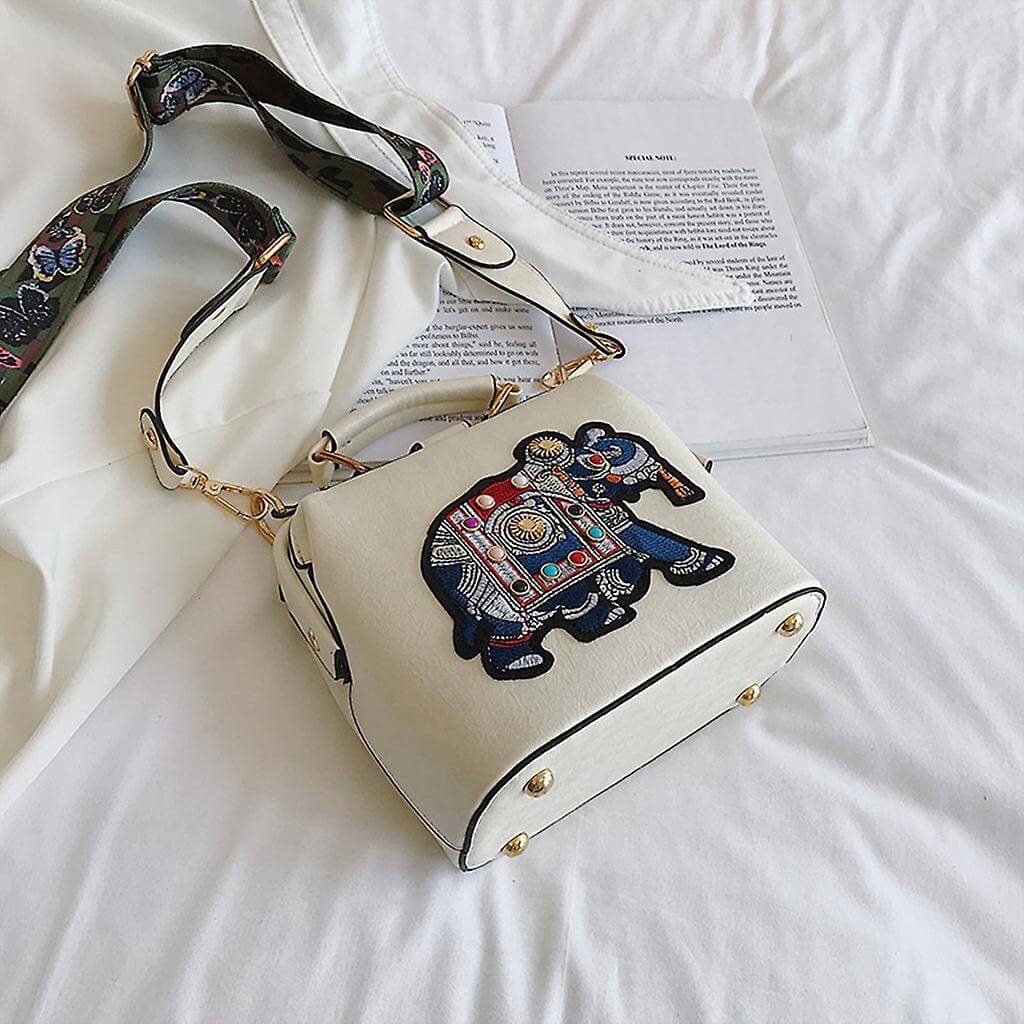 Frontal view of the vibrant embroidered mandala pattern on a women's shoulder bag.