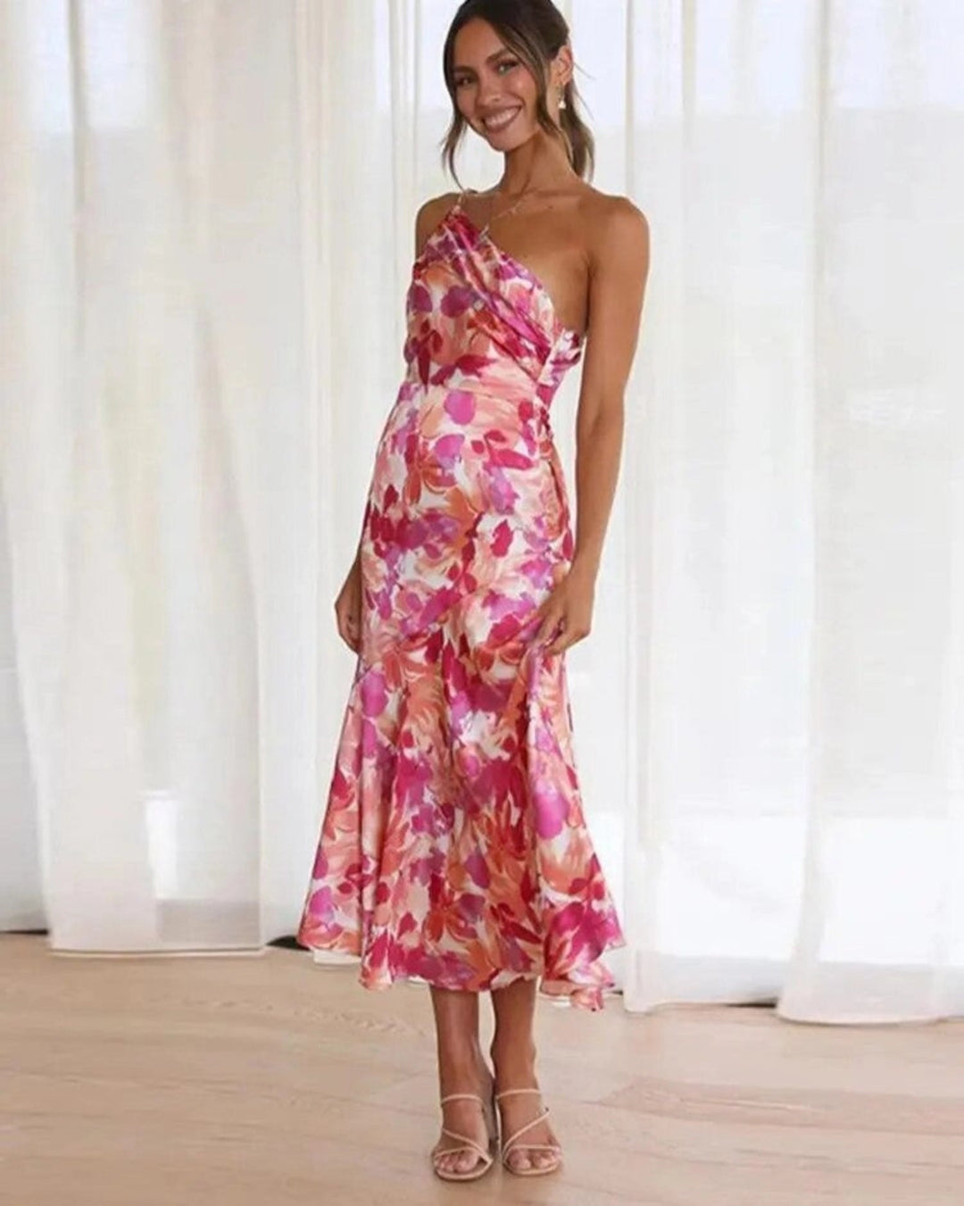 Vibrant floral asymmetric midi dress for women, sleeveless with a flowing hem, perfect for summer elegance.