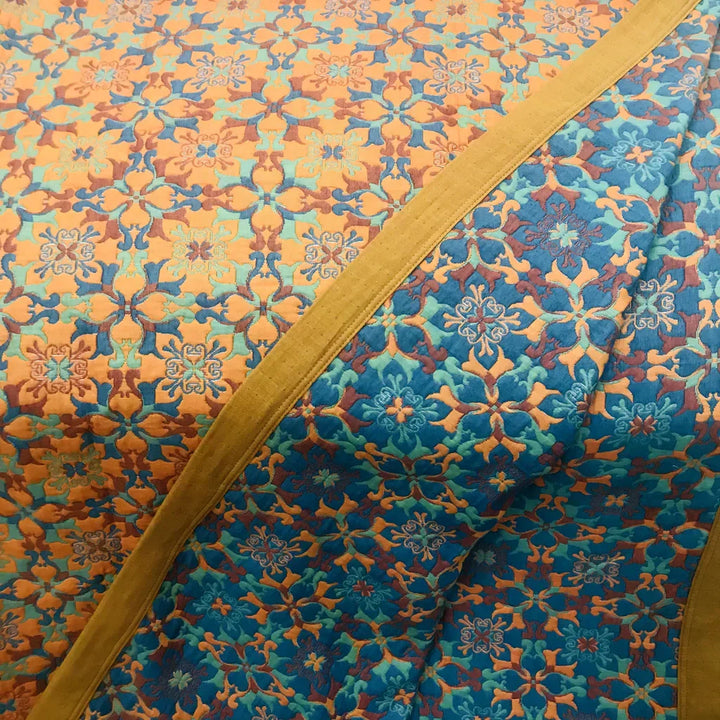Handcrafted orange & blue cotton quilt. Six-layer duvet offers superior comfort and vibrant bedding style.