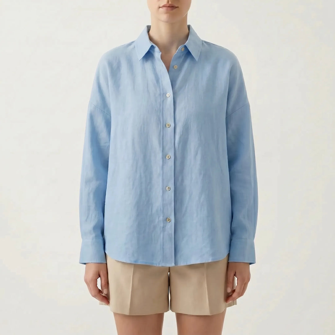 Effortless white oversized button-down shirt for women, a chic long sleeve casual top for relaxed summer fashion.