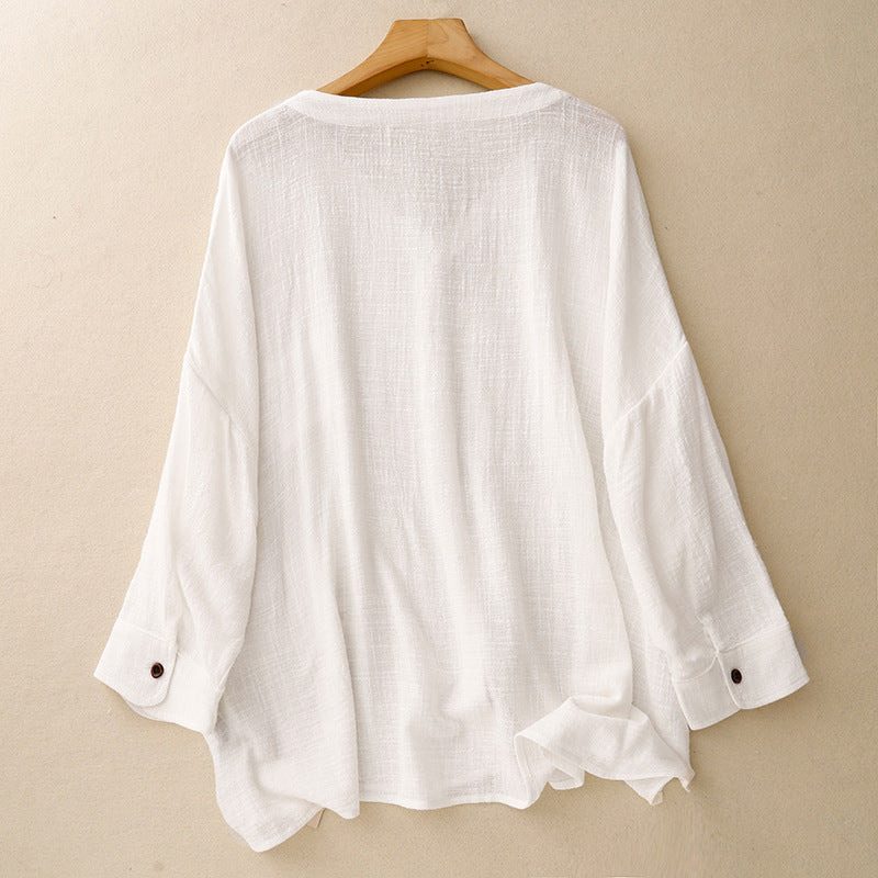 Stylish women's relaxed fit button-up shirt with an effortless drape and long sleeves, great for elegant spring casual wear.