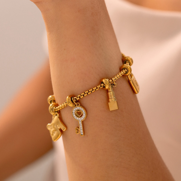 Close-up of unique, intricate charms on a women's adjustable bracelet. Elegant women's jewelry.