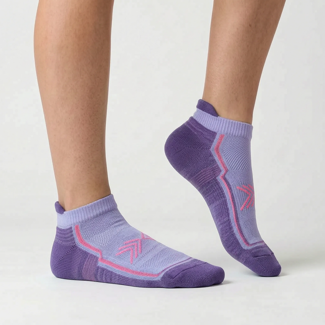 Green women's ankle-length running socks, essential performance workout gear.