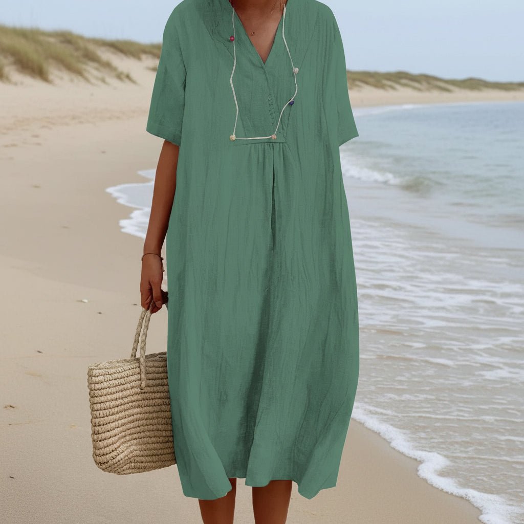Woman wearing a chic Aria V-neck A-line midi summer dress. Comfortable & stylish for any casual occasion.