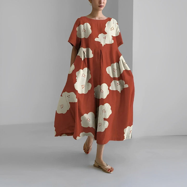 Summer fashion artistic print midi dress for women. Flowy, short sleeve, perfect for warm weather style.