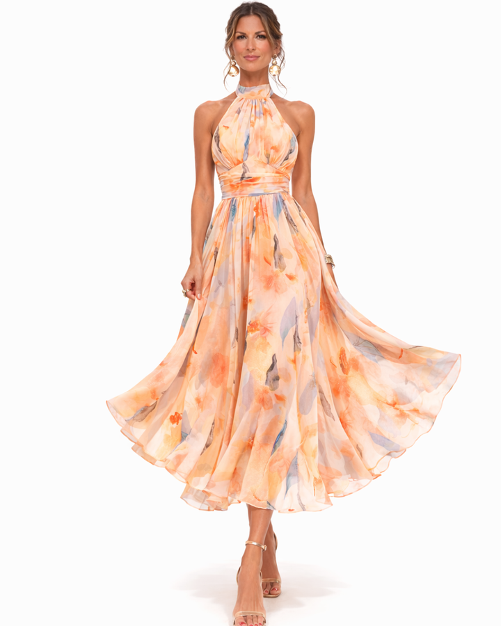 Elegant women's flowing maxi dress featuring vibrant watercolor print and stylish halter neckline.