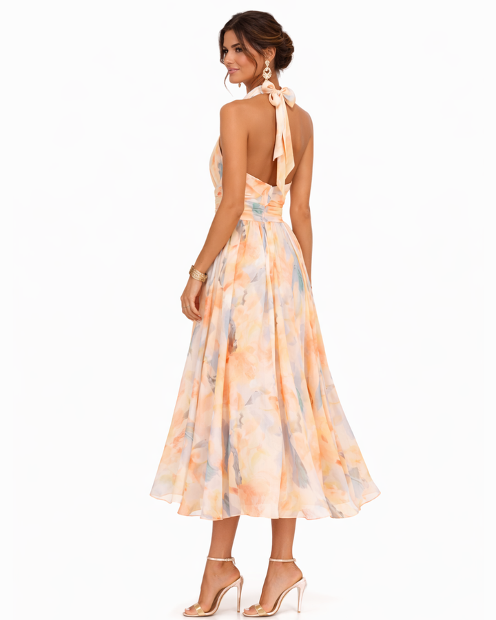Vibrant women's artistic watercolor print maxi dress with a chic halter neck for a breezy summer look.