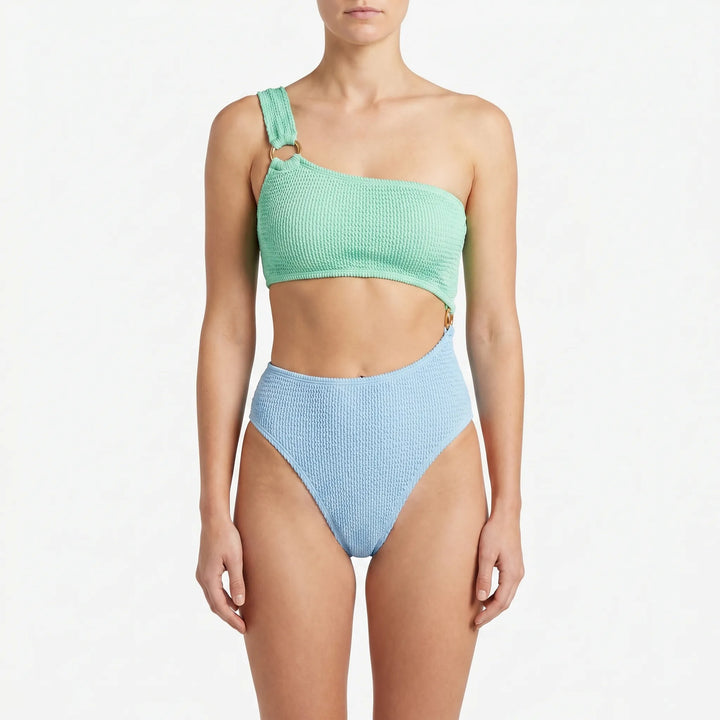 Women's trendy asymmetric monokini swimsuit with a modern cut-out design, great for resort & beach fashion.