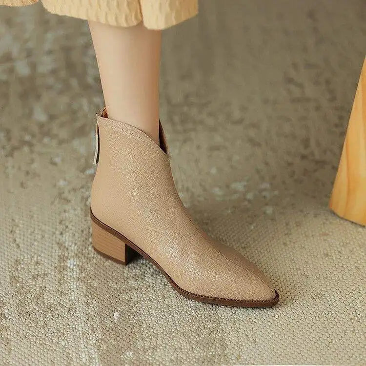 Sleek women's pointed-toe ankle boots, designed with a low heel for ultimate comfort and style.