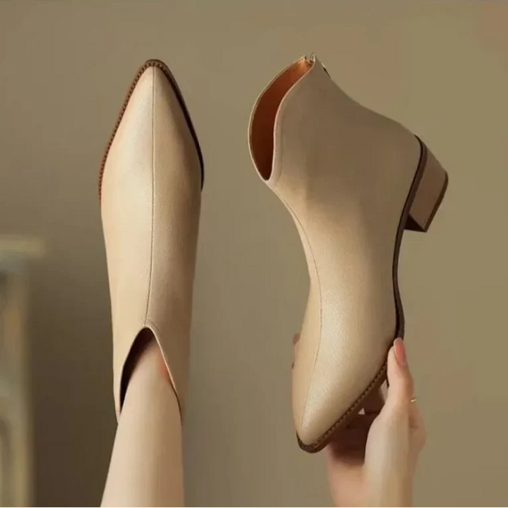 Easy slip-on women's ankle boots, featuring a fashionable pointed toe and stable low heel.