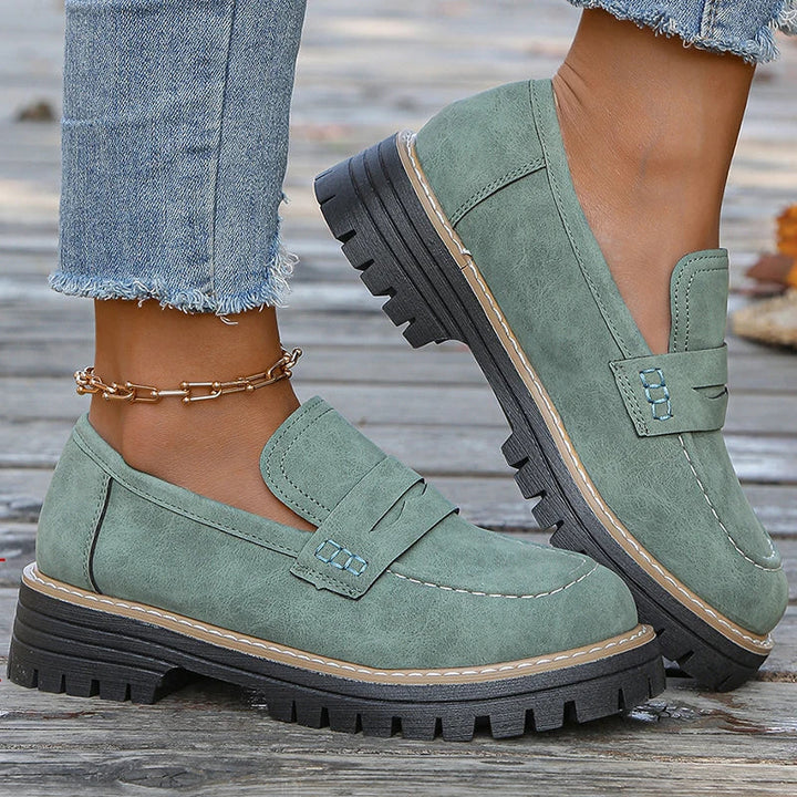 Fashionable women's loafers, black chunky platform design, offering comfort and modern style.
