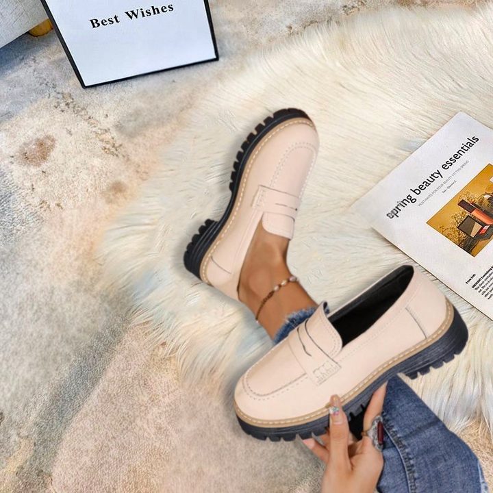 Women's chunky platform loafers with a round toe and lug sole, offering comfortable and trendy style.