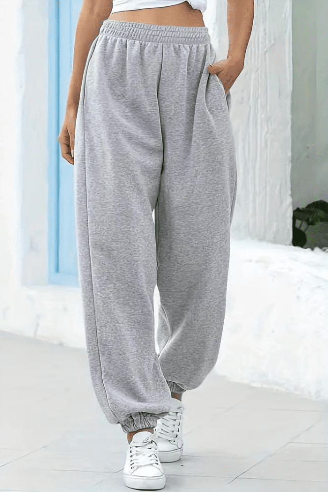 Women's black high-rise joggers, elastic waist, comfortable for lounging or casual everyday wear.