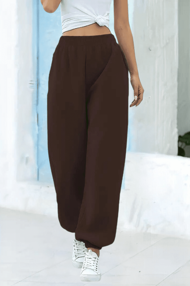 Women's high-rise joggers with elastic waist, side pocket detail, comfy casual pants.