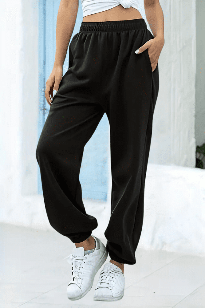 Rear view: women's black high-rise joggers, elastic waist for a flattering, comfortable fit.