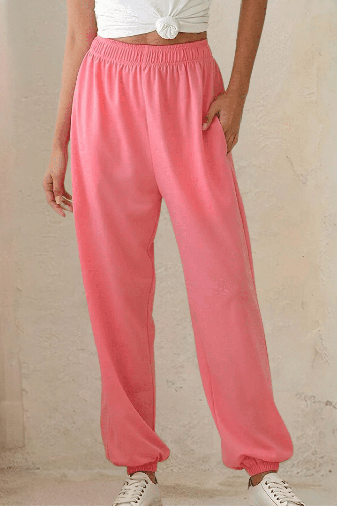 Versatile women's grey high-rise joggers with elastic waist, styled for an active yet comfy look.