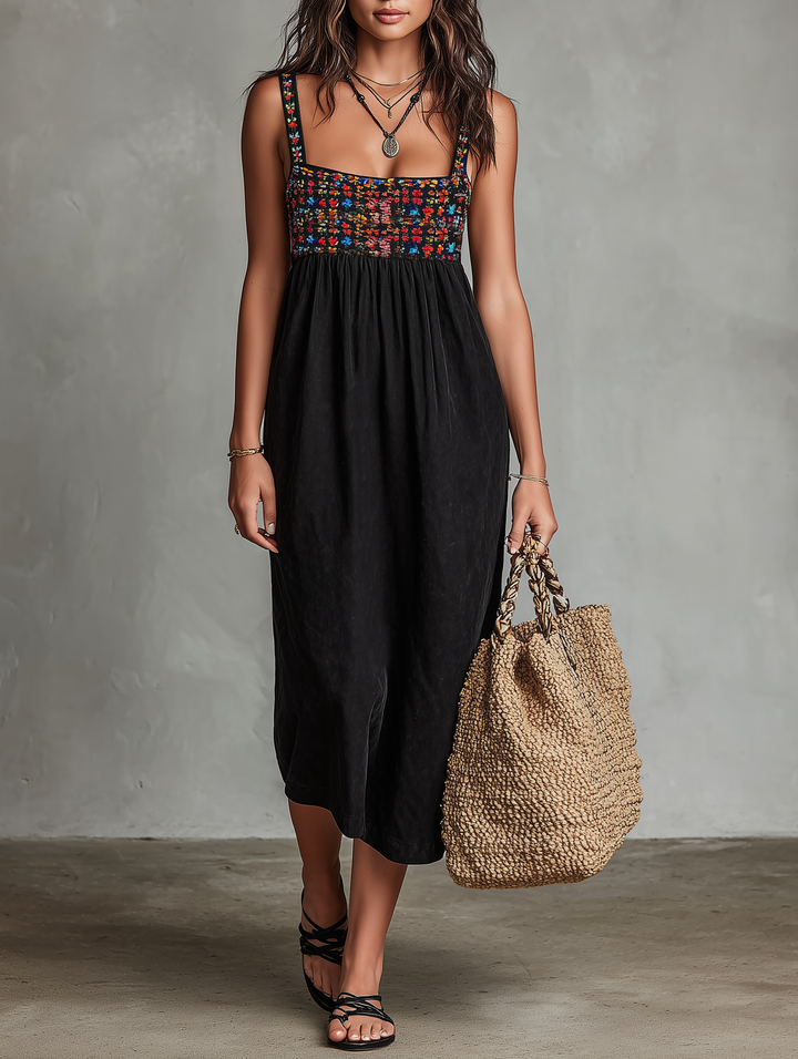 Women's black midi dress with vibrant floral embroidery, square neck, and sleeveless design for summer fashion.