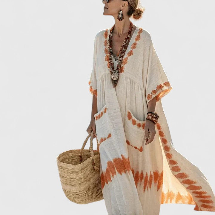 Stylish women's long boho maxi dress with handy pockets, ideal for warm weather comfort & casual wear.