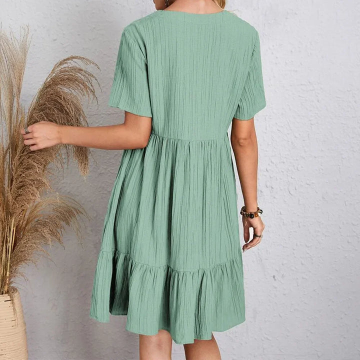 Comfortable women's bohemian V-neck summer dress, ideal for vacation or casual spring wear. Relaxed fit.