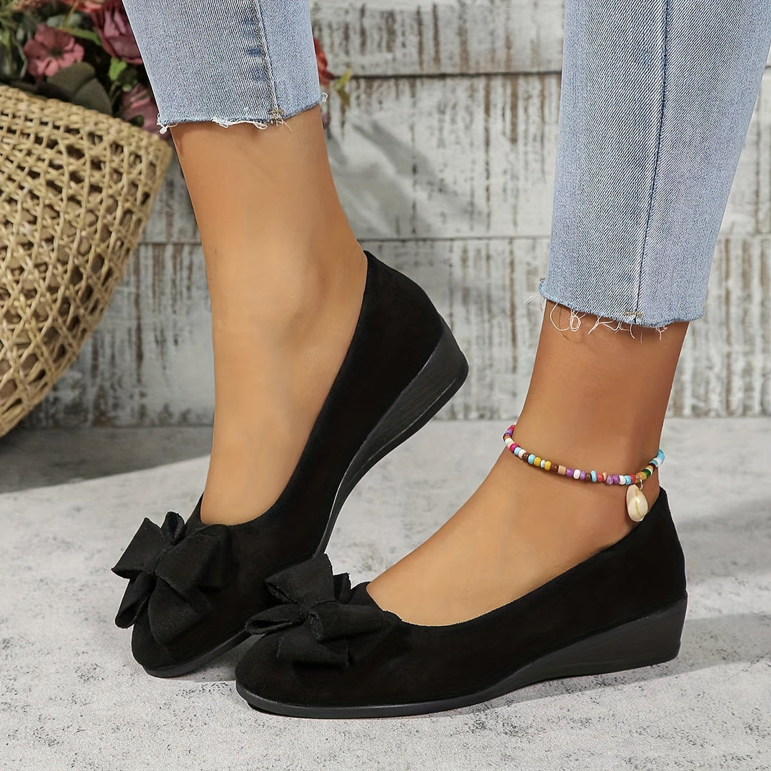 Feminine round toe wedge flats with a stylish bow, versatile for work & casual wear.