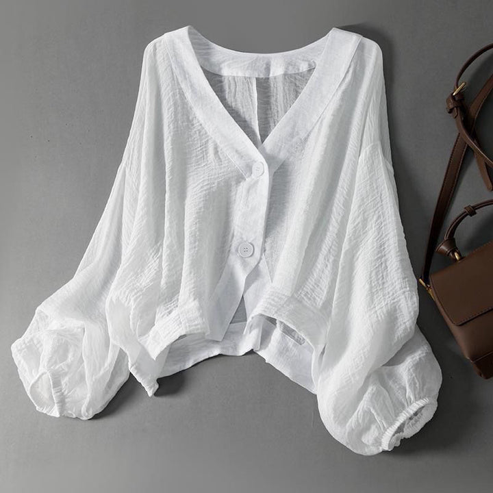 Women's breezy balloon sleeve blouse with textured fabric, perfect for effortless casual summer style.