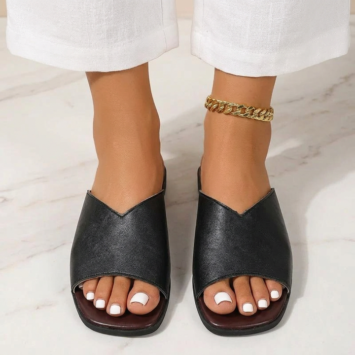 Cushioned slip-on women's flats, breezy open-toe design for casual summer footwear comfort.