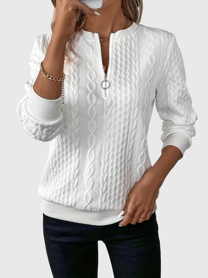 Stylish women's quarter-zip sweater with elegant cable pattern.