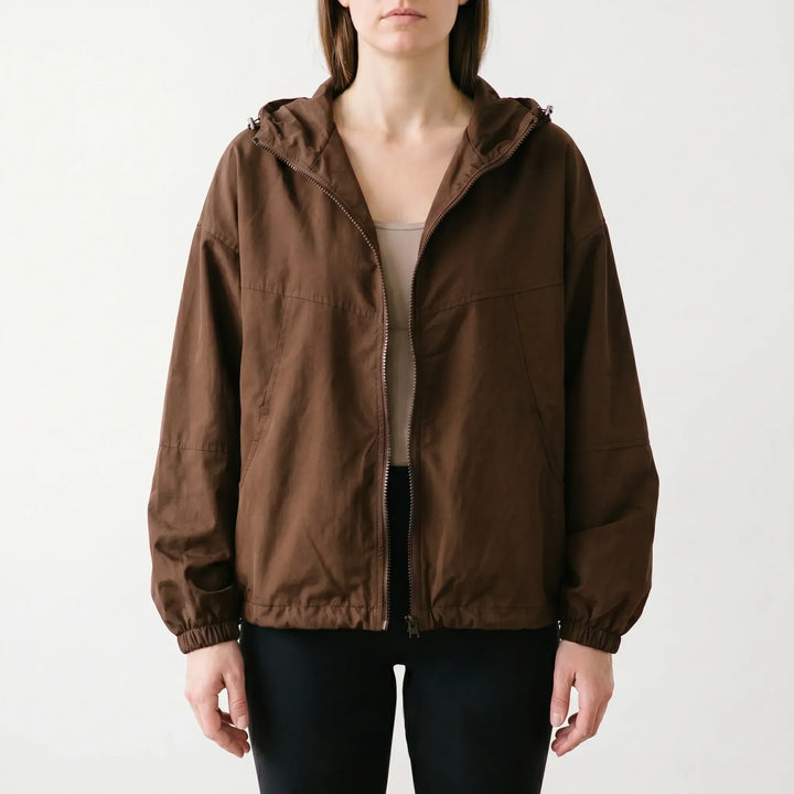 Versatile women's hooded windbreaker jacket. A lightweight, casual outerwear piece for active lifestyles and daily fashion.