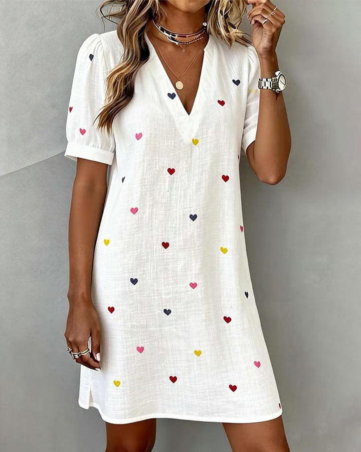 Women's casual mini dress with puff sleeves & heart print, V-neck, perfect for summer daytime wear. Relaxed fit.